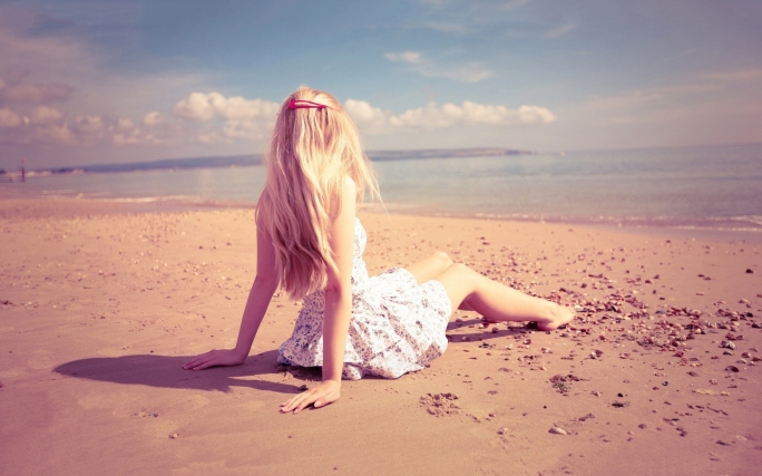 lonely-girl-sitting-on-beach